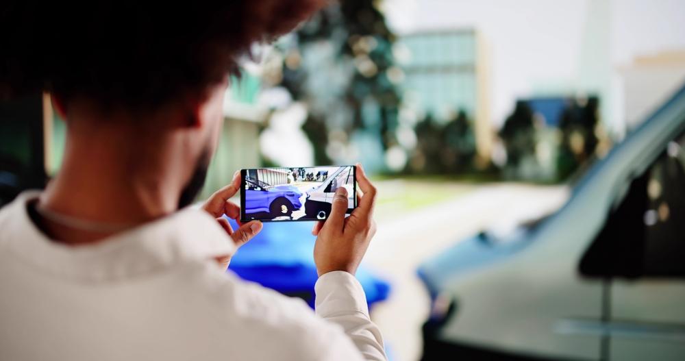 Insurance adjuster taking photos of car accident for claim process