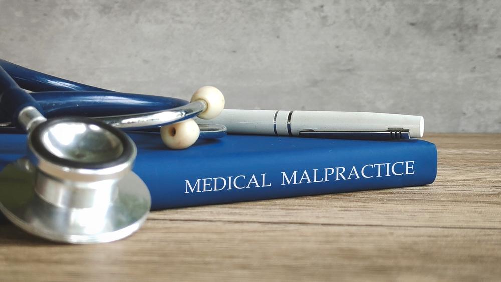 Stethoscope and a pen on a book