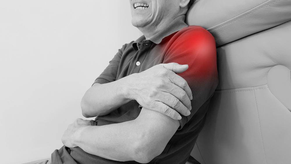 Elderly man suffering from shoulder pain