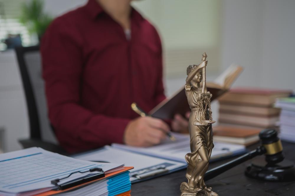male lawyer meticulously reviews legal documents