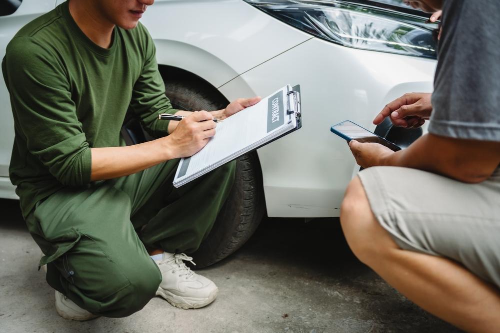 men discussing car insurance policies with adjuster
