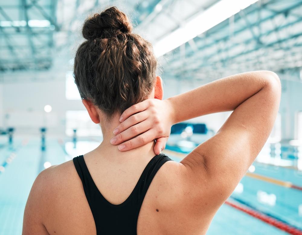 neck pain and fitness with woman at swimming pool