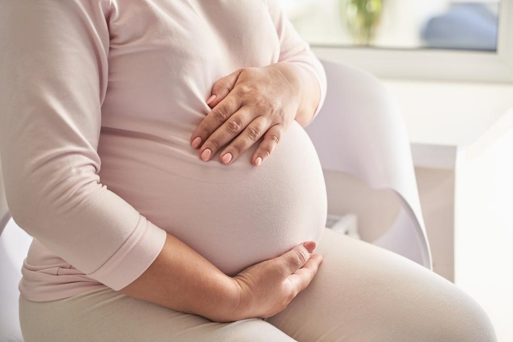 pregnant female sitting on sofa