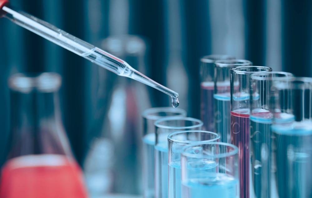 researcher with glass laboratory chemical test tubes