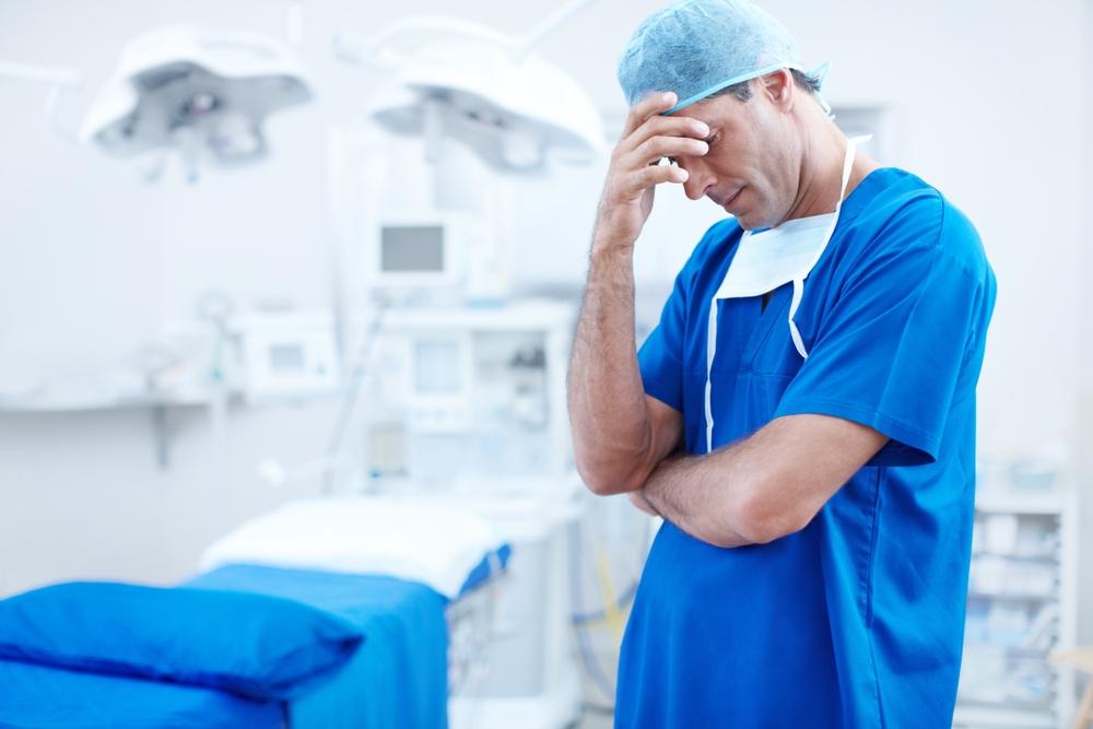 surgery and stress with man in hospital for patient loss