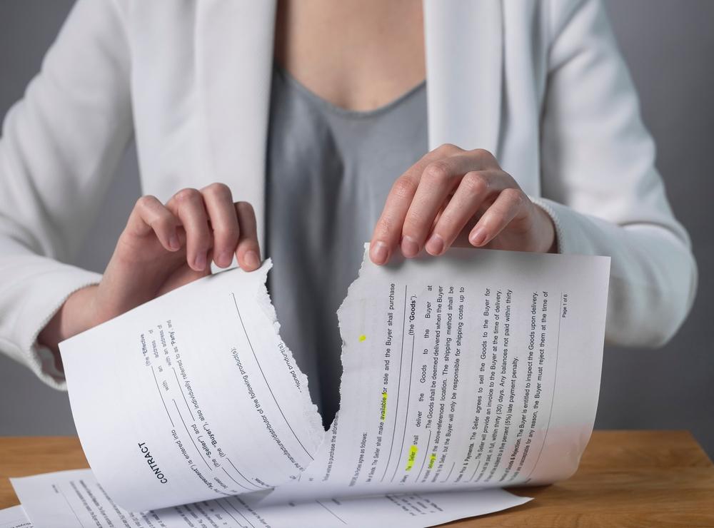 Torn contract in hands