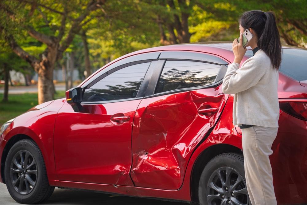 Young Asian woman after car accident